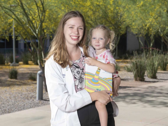 Elizabeth Borden, PhD, holding her 3-year-old daughter, Miriam