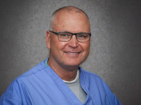 portrait of Dr. Ken Johnson in blue scrubs