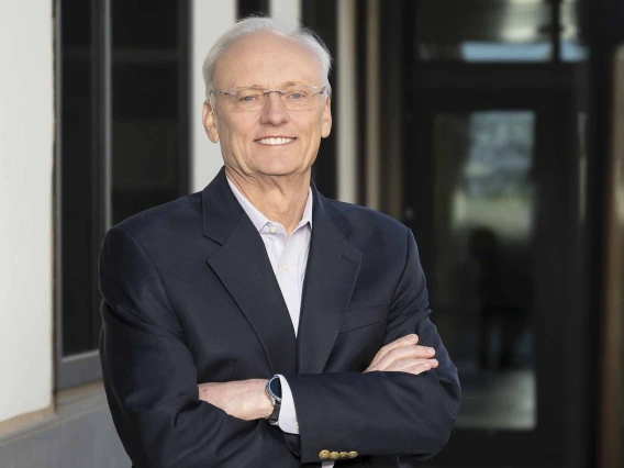 Portrait of Rick G. Schnellmann, PhD, standing with his arms folded in front of him.