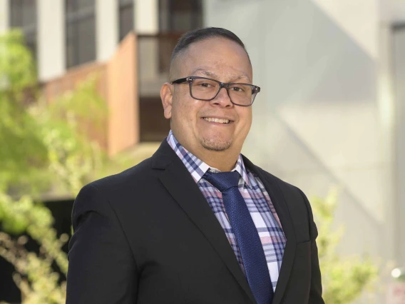 Portrait of Alejandro Vazquez, PharmD, standing outside smiling. 