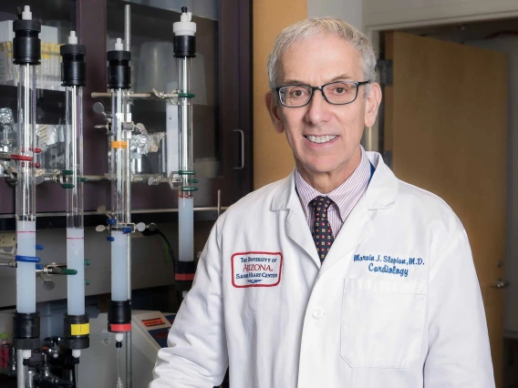 Portrait of Marvin Slepian, MD, JD, in a white doctor’s coat.