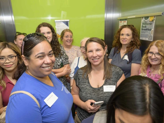 A group of educators crowds into an elevator at the Phoenix Bioscience Core. 