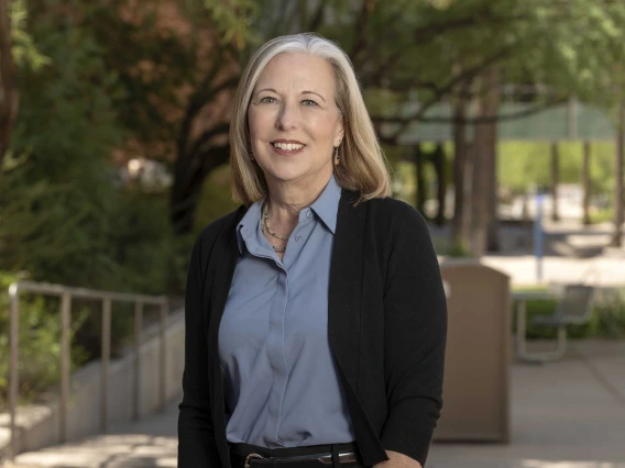 Portrait of Dr. Kristen Rundell smiling as she stands outside. 