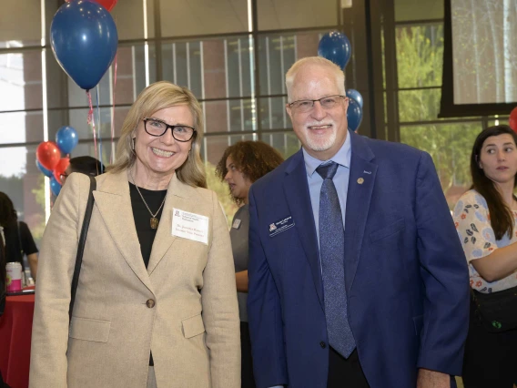 Photo of Jennifer Barton, PhD, interim vice provost for health programs, stands next to Kevin Lohenry, PhD, PA-C, vice dean of Health Professions Affairs and executive director of the School of Health Professions.