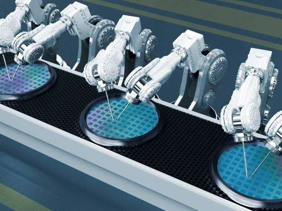 Six white robot arms working on blue circles on a semiconductor manufacturing line