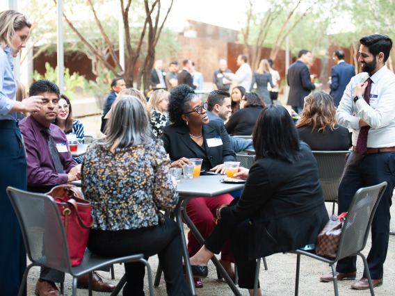 Attendees of the All of Us UArizona-Banner VIP reception at the Phoenix Bioscience Core campus network in the Grand Canyon courtyard during a beautiful spring evening. 