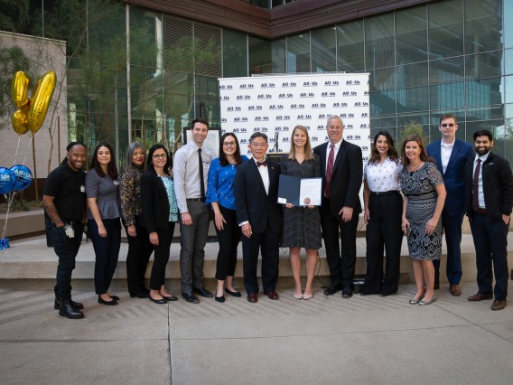 Members of the All of Us UArizona-Banner team pose with Barry Wong, JD, (center with bow tie) director of the Governor’s Office of Equal Opportunity, after he presented the governor’s proclamation declaring March “Arizonans in Health Research Month.” 