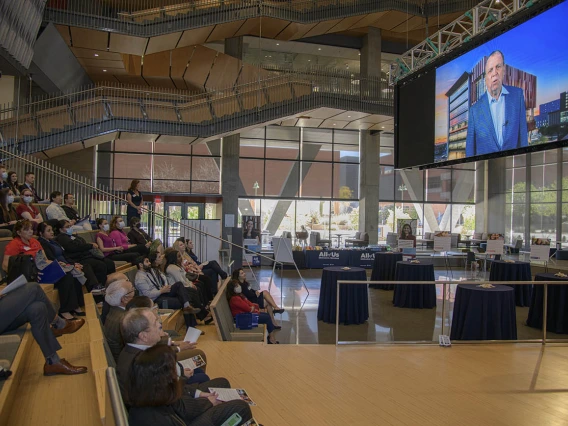 Attendees of the 50k Strong Arizona Celebration and Research Showcase watch the 50K Strong Arizona video at the beginning of the event held in the Health Sciences Innovation Building on the Tucson Campus. 
