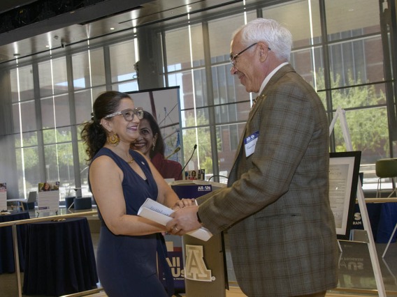 Lydia Aranda, president, Southern Arizona/Border Communities at Chicanos Por La Causa, greets Francisco Moreno, MD, associate vice president for UArizona Health Sciences Equity, Diversity and Inclusion, at the 50k Strong Arizona Celebration and Research Showcase in the Health Sciences Innovation Building on the Tucson campus.