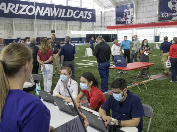 A new use for a practice field, testing is conducted in this climate controlled temporary clinic set up inside the Cole and Jeannie Davis Sports Center.