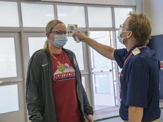 Upon arrival at the testing facility, all individuals are required to wear a mask, and have their temperature checked by health care personnel.