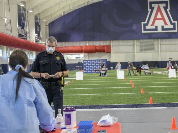 A Tucson-area police officer waits to be called to give a blood sample for the antibody test. 