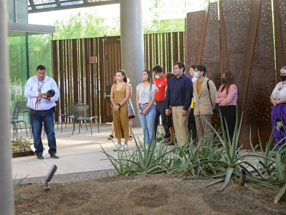 Participants gather before the start of the blessing ceremony in the Grand Canyon area at the Phoenix Bioscience Core as Miguel Flores Jr. (left) prepares to lead the ceremony. 