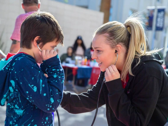 Pharmacy student listens to child's heartbeat; More than 9,000 kids attended 2020 Connect2STEM.