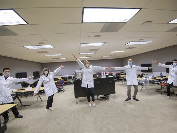 Members of Santa Rita House model face masks and white coats. From left: Daniel Nguyen, Bailey Antonowicz, April Huckleberry, Ethan Hill and Ahmed Al-Shamari.