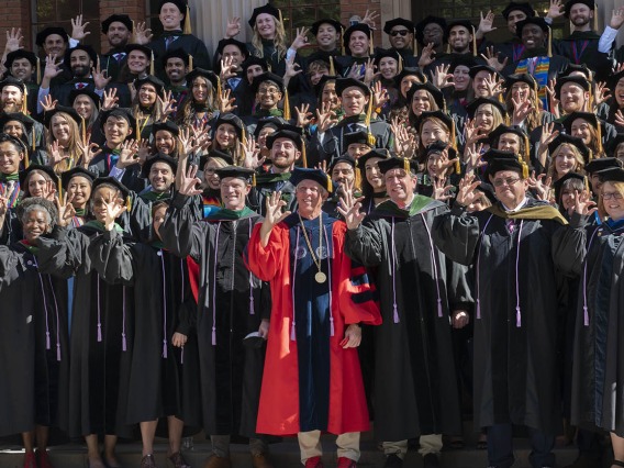 UArizona College of Medicine – Tucson graduates, faculty and staff give the Wildcat sign as they gather for a group photo after the class of 2022 convocation at Centennial Hall.