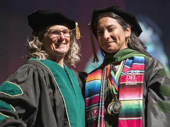 Professor Patricia Lebensohn, MD, poses for a photo with Naiby Rodriguez Zuniga, MD, after hooding her during the College of Medicine – Tucson class of 2022 convocation at Centennial Hall. 
