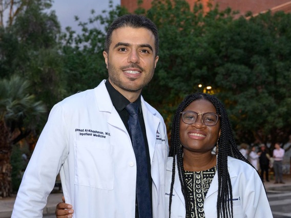 Assistant professor Ahmad Al-Khashman, MD, pauses for a photo while congratulating Chizitaram (Vanessa) Ogbuji after she received her white coat at the UArizona College of Medicine – Tucson Class of 2026 white coat ceremony.