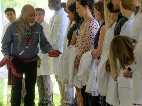 Carlos Gonzales, MD, blesses each participant in the Tree Blessing Ceremony with the smoke of the sacred herbs. Dr. Gonzales is the assistant dean of curricular affairs for the College of Medicine – Tucson. 