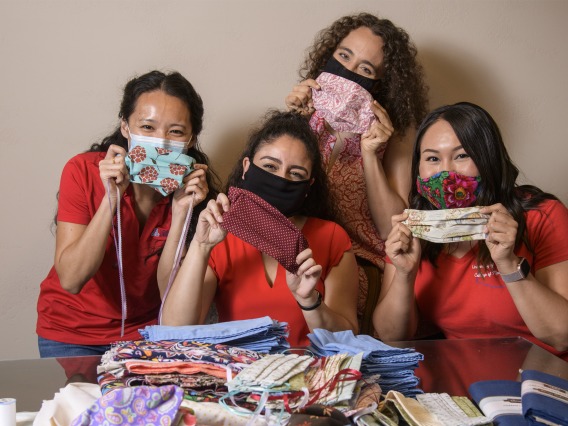 University of Arizona College of Medicine – Tucson students in the Commitment to Underserved People Program held a drive to help the Navajo Nation during the COVID-19 pandemic. Students Lynn Pham, Guadalupe Davila, Nicole Bejany and Thomasina Blackwater hold up face masks they sent to the Navajo Nation.