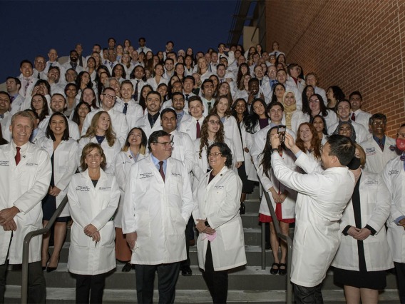 Keynote speaker, Bert B. Vargas, MD, (lower right) takes a picture of the UArizona College of Medicine – Tucson class of 2024 after their white coat ceremony. 