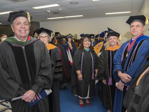 Senior Vice President for Health Sciences, Michael D. Dake, MD, (left) prepares to take the stage with UArizona College of Nursing faculty and staff before the start of their 2022 spring convocation at Centennial Hall.