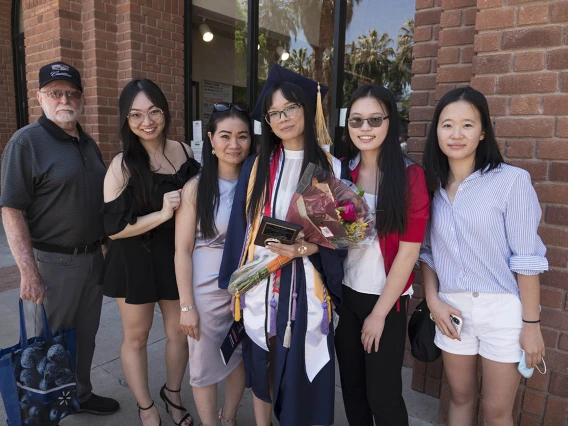 Lina Thai, who earned her Bachelor of Science in Nursing, stands with her family after the UArizona College of Nursing 2022 spring convocation at Centennial Hall.