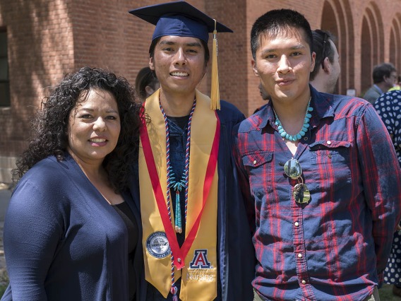 Lydia Parra (left), coordinator for the UArizona College of Nursing’s ANIE Program, takes a photo with Bachelor of Science in Nursing graduate Joshua Billy and his brother, Justin Billy after the College of Nursing 2022 spring convocation at Centennial Hall.