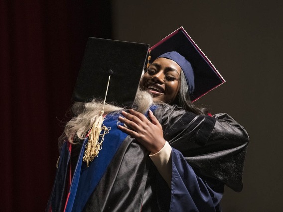 Jasmyn Countee (right) hugs Melissa Goldsmith, PhD, RNC, after being pinned and receiving her Bachelor of Science in Nursing during the UArizona College of Nursing 2022 spring convocation at Centennial Hall.¬