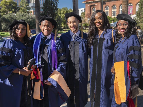 Doctor of Nursing Practice students (from left) Christiana Billedalley, Brian Harris, AZ Del Pino, Kengne Fosso and Jossy Mossle pause for a photo before heading into Centennial Hall for the College of Nursing fall convocation.