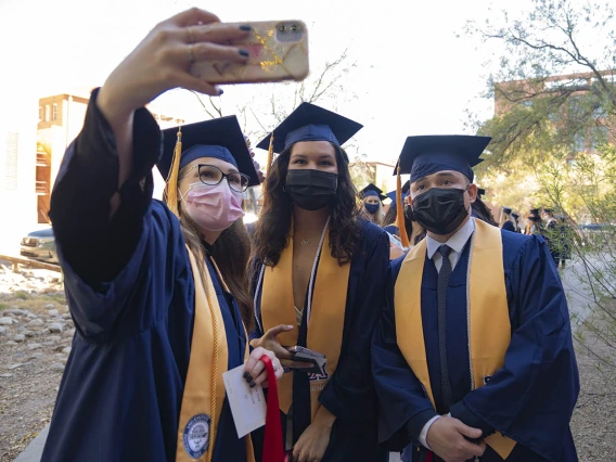 Nicole Cook takes a selfie with her fellow College of Nursing graduates, Gianna DeCero and Tom Dang at their fall convocation.