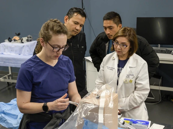 University of Arizona College of Nursing Doctor of Nursing Practice students practice a spinal block on a manikin during a clinical immersion session.