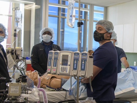 Certified Registered Nurse Anesthetists students watch the monitors in the Arizona Simulation Technology and Education Center after administering medication to a manikin during a simulation.