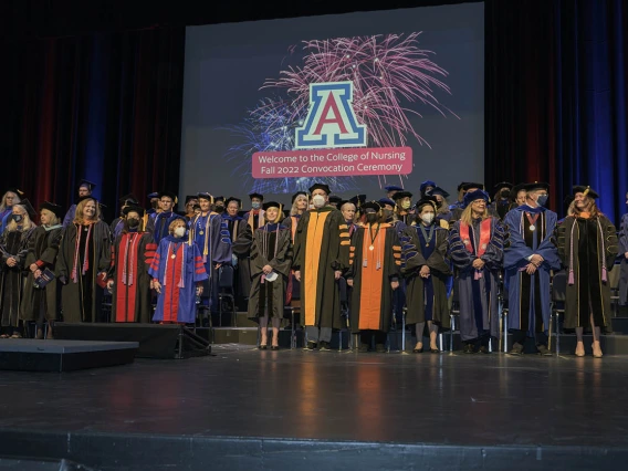 Michael D. Dake, MD, (center) senior vice president for the University of Arizona Health Sciences, is surrounded by College of Nursing faculty members at the college’s fall convocation at Centennial Hall on Dec. 15. 