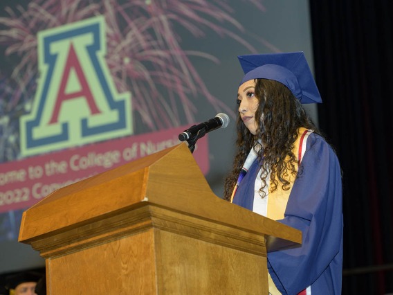 Mariafernanda Osornio, who earned a Bachelor of Science in Nursing – Integrative Health, gives the Spanish language welcome to attendees at the UArizona College of Nursing fall convocation in Centennial Hall on Dec. 15. 