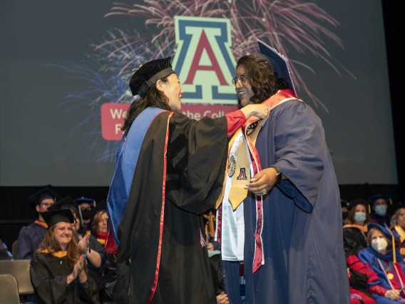 (From left) Assistant clinical professor Sharon Hom, PhD, MS, RN, presents Angela Acuna with the UArizona College of Nursing INCATS Program award at the college’s fall convocation at Centennial Hall on Dec. 15.