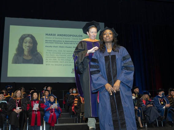 Doctor of Nursing Practice graduate Marie Andriopoulos is hooded during the UArizona College of Nursing fall convocation by assistant clinical professor Robin Poedel, PhD, RN, FNP-BC.