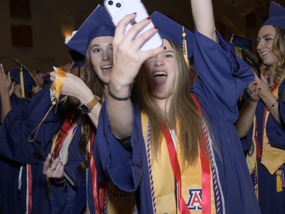 (From left) Bachelor of Science in Nursing graduates Bobbi Jackson and Katya Kirkland celebrate with a selfie during the UArizona College of Nursing fall convocation in Centennial Hall on Dec. 15.