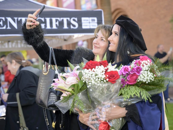 Doctor of Nursing Practice graduate Dragana Vojvodic (right) takes a photo with her mother, Drazana Kupusovic, at the UArizona College of Nursing fall convocation in Centennial Hall on Dec. 15.