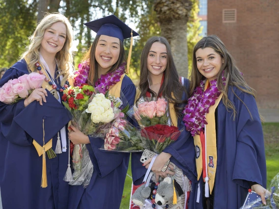 (From left) UArizona College of Nursing Bachelor of Science in Nursing – Integrative Health graduates Tiffany Kalk, Eunice Jung, Sydney Johnson and Gigi Steiner pause for a photo outside of Centennial Hall after the college’s convocation. 