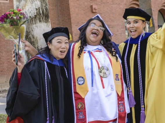 Assistant clinical professors Sharon Hom, PhD, MS, RN, (left) and Timian Godfrey, DNP, APRN, FNP-BC, (right) celebrate with Angela Acuna, who completed her Bachelor of Science in Nursing degree.