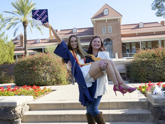 Bachelor of Science in Nursing – Integrative Health graduate Riley Kuderca celebrates with her friend Amanda Regrendele at the UArizona College of Nursing fall convocation.