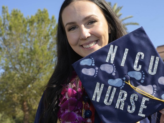 Madelyn Askew shows her decorated mortarboard after   receiving her Bachelor of Science in Nursing – Integrative Health degree at the UArizona College of Nursing fall convocation at Centennial Hall on Dec. 15.