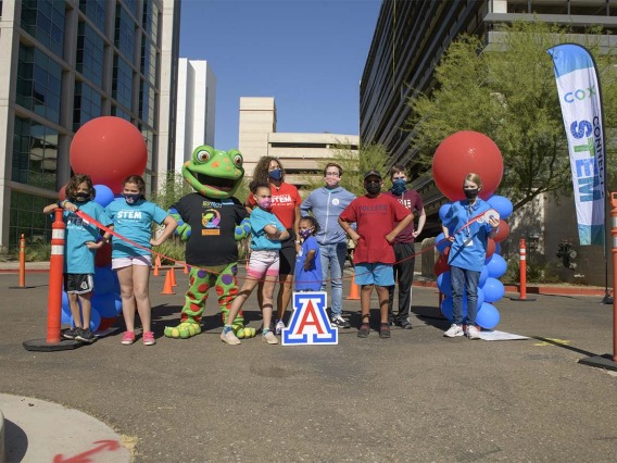 Volunteers and University of Arizona Health Sciences staff stand ready to open the 2021 Connect2STEM drive-through event at the Phoenix Biomedical Campus parking garage.