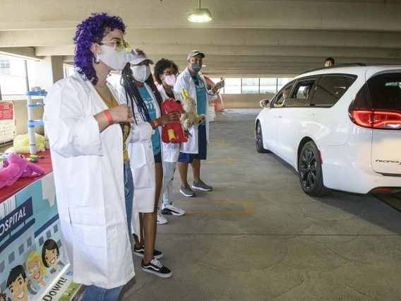 Students from the College of Medicine – Phoenix visit with kids as their parents slowly drove by the Wildcat Play Hospital, run by the Black African American Caribbean Employee Resource Group.