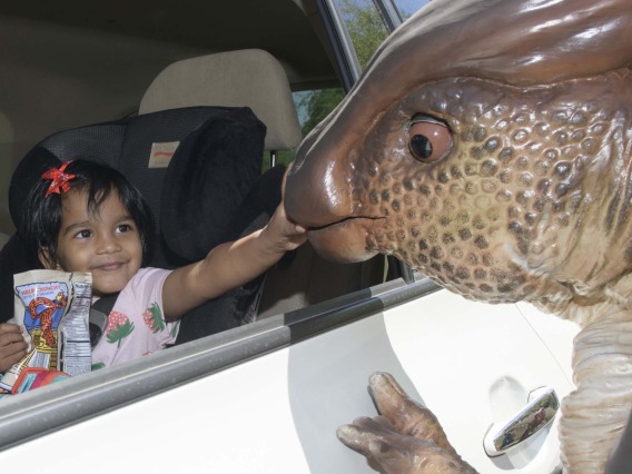 A costumed dinosaur character brought science to life for visitors attending an innovative drive-through Connect2STEM event in Phoenix on Saturday, May 22, 2021. 