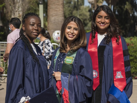 (From left) Mavis Obeng-Kusi, MSPS, Nouf Bin Awad, MSPS, and Srujitha Marupuru, PhD, pose for a photo before the start of the R. Ken Coit College of Pharmacy 2022 spring convocation at Centennial Hall.
