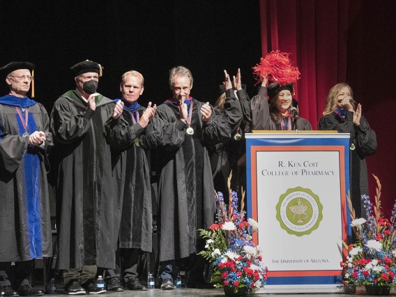 UArizona Health Sciences Senior Vice President Michael D. Dake, MD, (second from left) joins the R. Ken Coit College of Pharmacy faculty and staff in cheering on graduating students as they walk into Centennial Hall at the start of the 2022 spring convocation at Centennial Hall. 