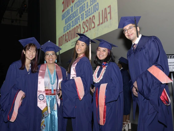 (From left) Master of Public Health graduates Sue Kim, Breanna Lameman, Geneva Frank, Kaitlyn Aoki and Samuel Farrow pause backstage at Centennial Hall before walking on stage to be hooded during the Mel and Enid Zuckerman College of Public Health fall convocation. 