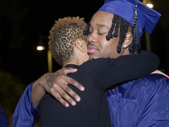 Master of Public Health graduate Malcolm Wilson hugs his mother, LaTonya Price, after the Mel and Enid Zuckerman College of Public Health fall convocation. 